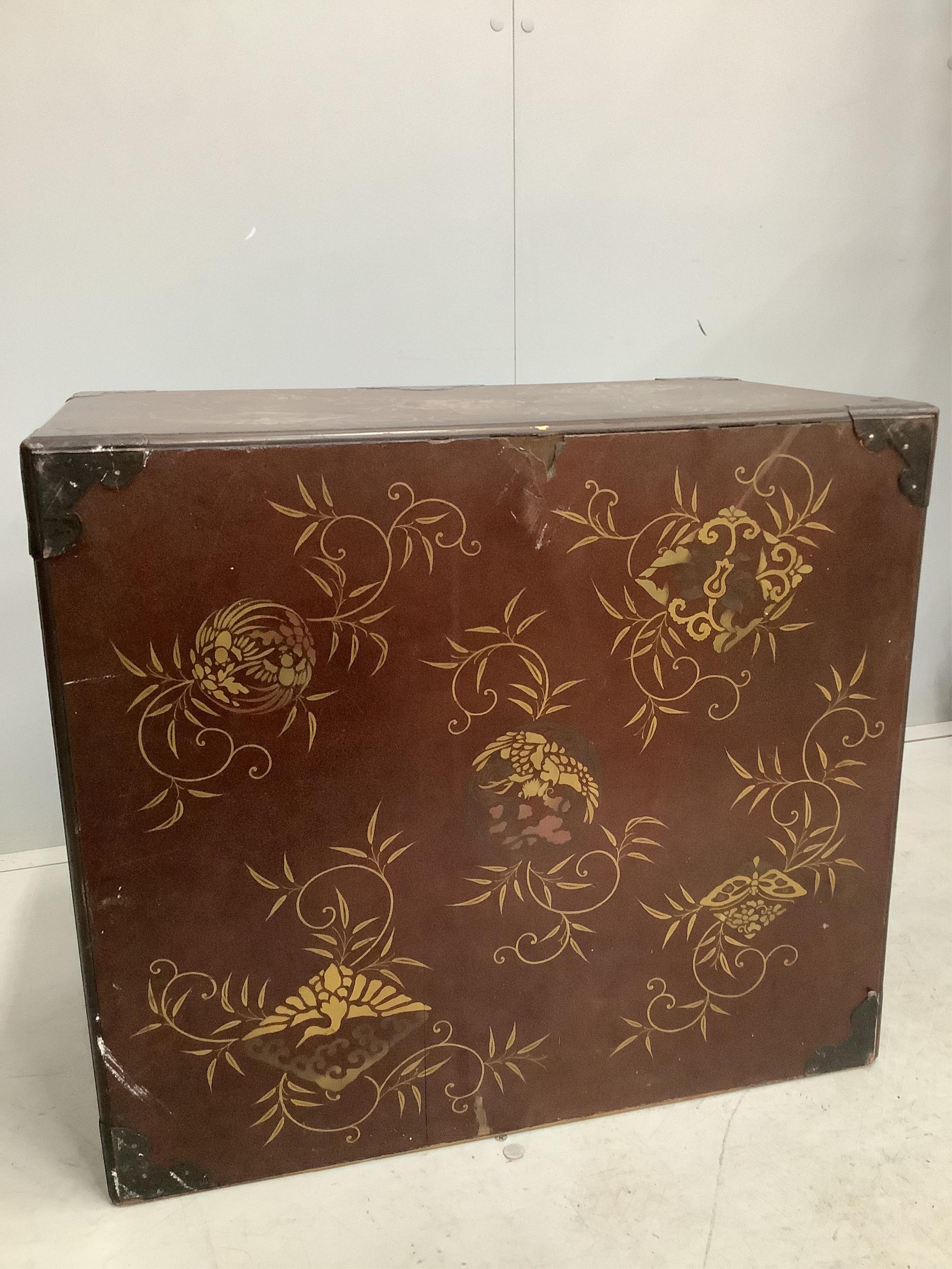 A 19th century Japanese gilt decorated lacquer table cabinet with two doors enclosing three drawers, width 61cm, depth 36cm, height 54cm. Condition - fair to good